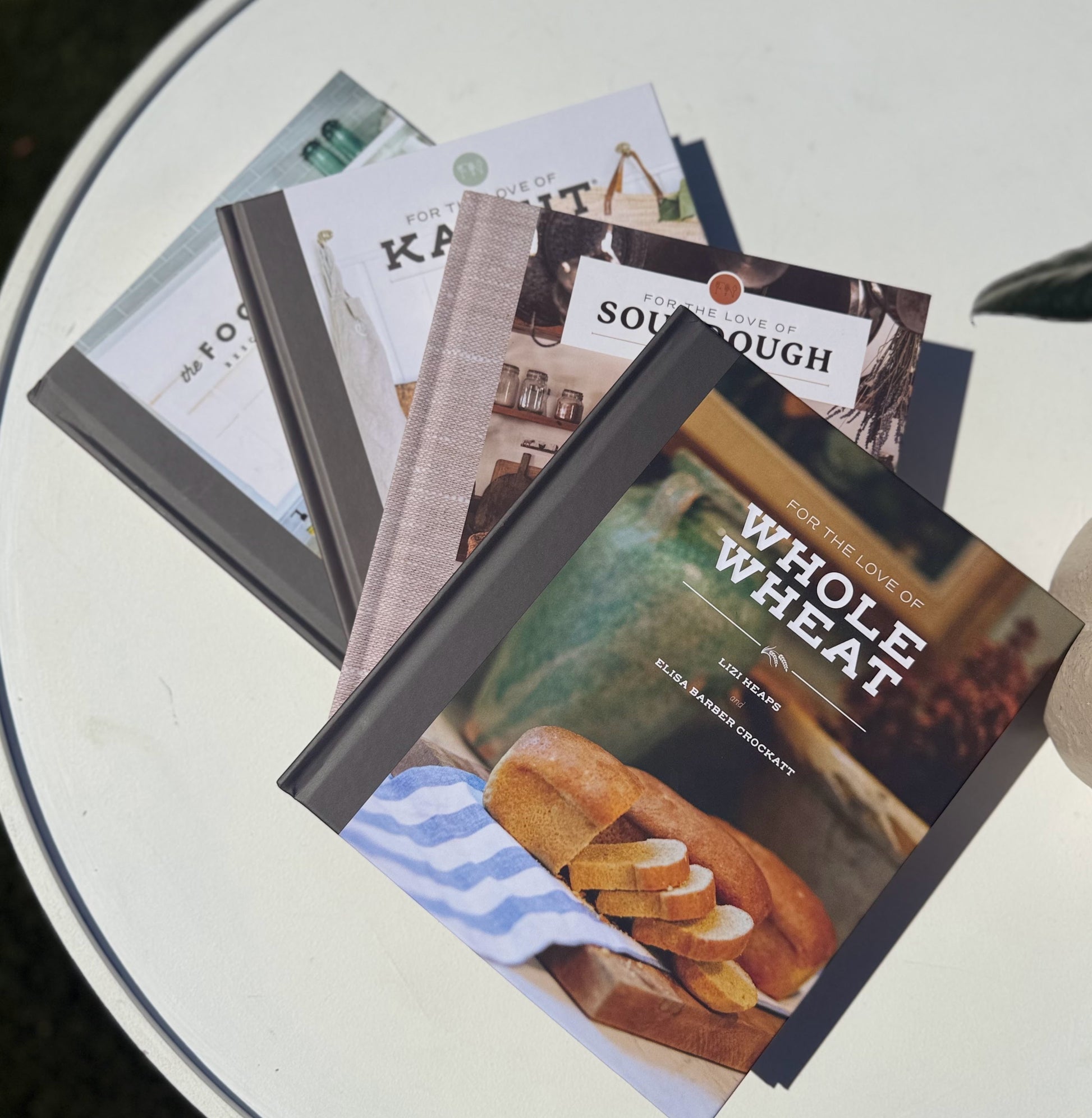 Collection of cookbooks on a white surface