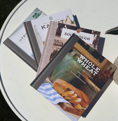 Collection of cookbooks on a white surface