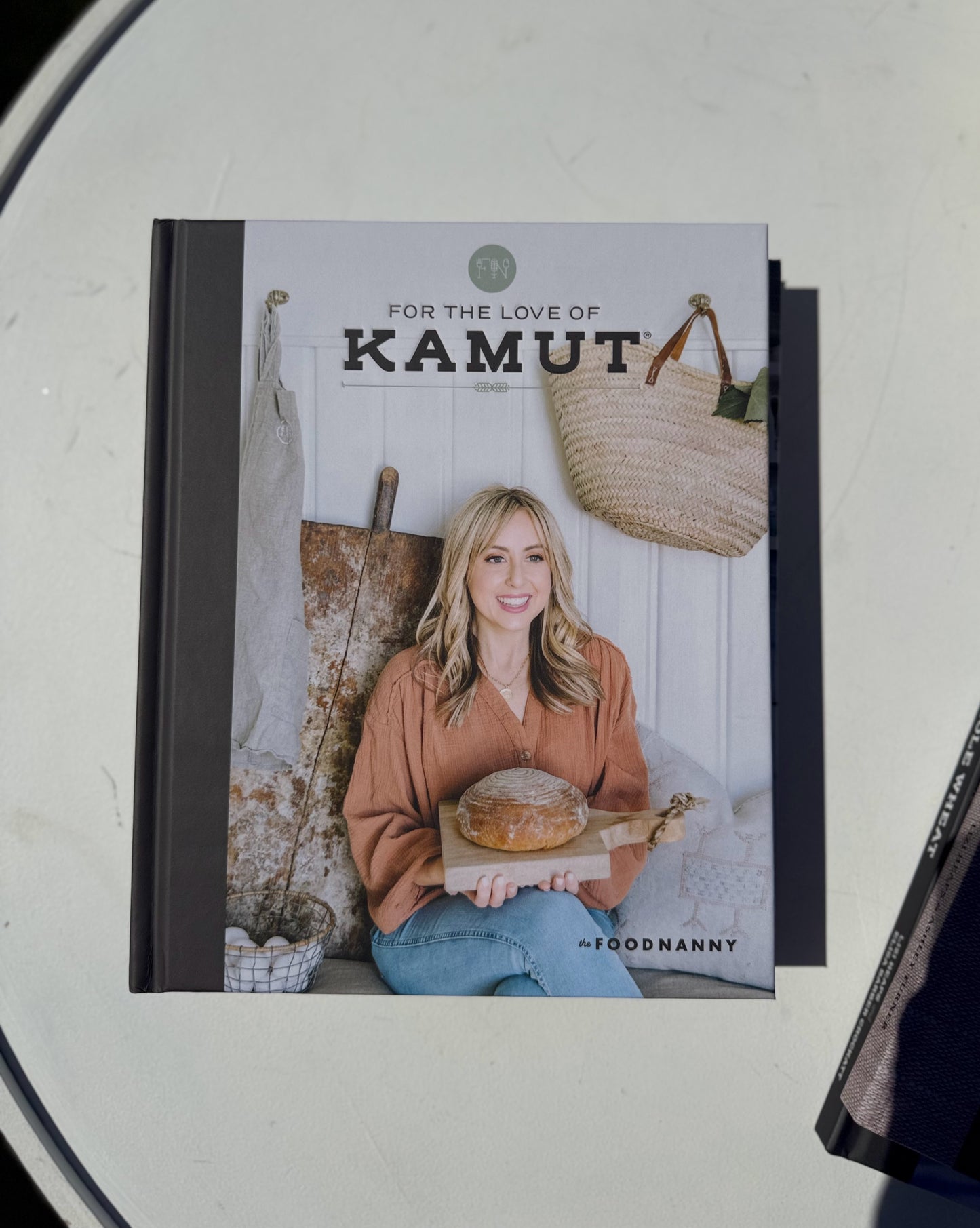 Book titled 'For the Love of Kamut' by The Foodnanny on a white surface