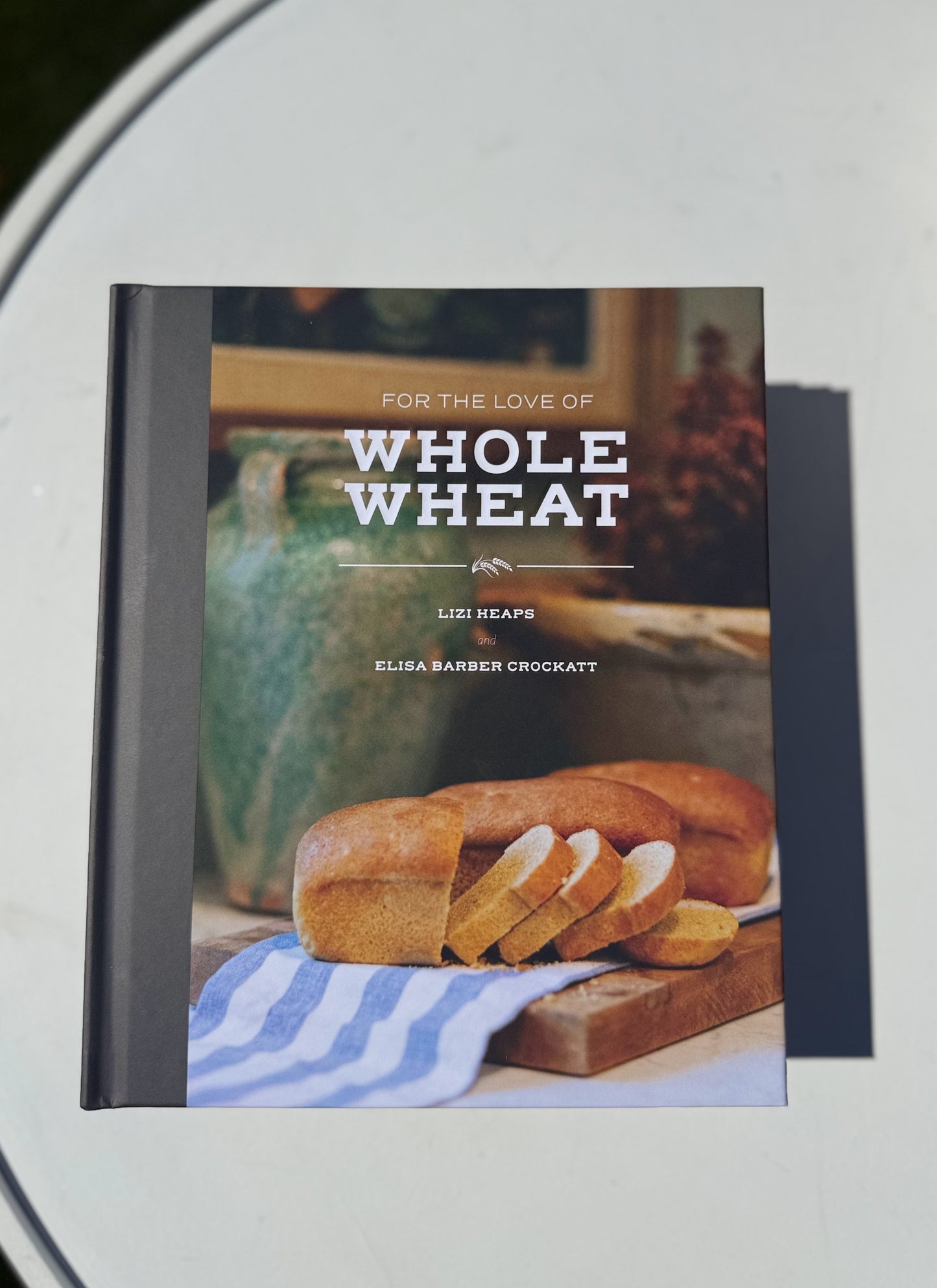 Book titled 'For the Love of Whole Wheat' with a loaf of bread on the cover.